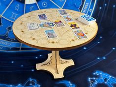 a wooden table topped with lots of cards on top of a blue floor covered in stars