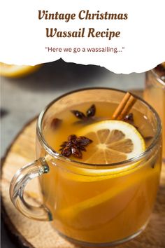 a glass mug filled with liquid and topped with orange slices, cinnamon sticks and star anise