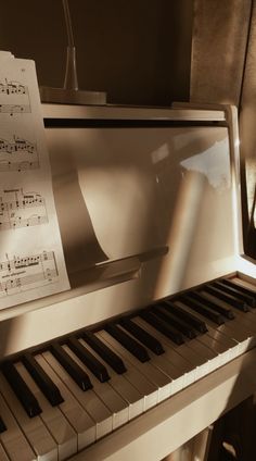 a piano with sheet music sitting on top of it