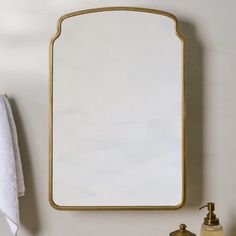 a bathroom sink with a mirror and soap dispenser