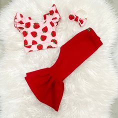 Beautiful strawberry bell pants and crop top. Perfect for strawberry themed birthdays.  The little bow sizes Newborn-2t comes on nylon, the 3t sizes and up will come on alligator clip  The set is made of ribbed stretchy knit fabric. Runs true to size. I won't recommend sizing up.  Size-inseam of leggings/waist  NB-6"/13" 0-3m-7"/14.5" 3-6m-8"/15.5" 6-9m- 9"/16" 9-12m-10.5"/16.5" 12-18m-11.5"/17.25" 18-24m-13"/18" 2-3t-14.5"/18.5 3-4t-15"/19" 4-5y-15.5"/19.5" 5-6y-16"/20" Berry First Birthday Outfit, Strawberry Pants, Baby Birthday Themes, 1st Birthday Themes, Bell Pants, Baby Planning, First Birthday Outfits, Birthday Party Dress, Girls Clothing Sets