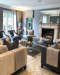 a living room with couches, chairs and a fire place in the fireplace area