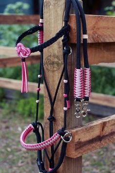 a horse bridle with pink and black braiding on it's sides