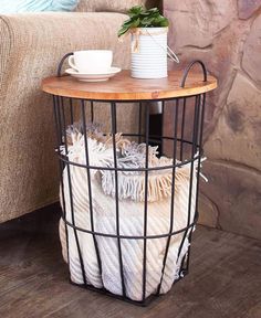 a table with a basket on it and a coffee cup sitting on top of it