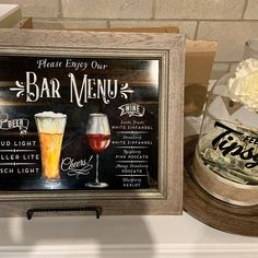 there is a sign that says bar menu and two glasses of wine on the counter