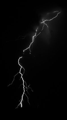 a black and white photo of lightning in the sky