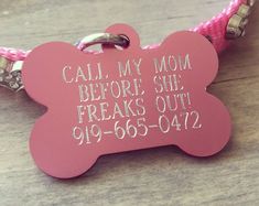 a pink dog tag that says, call my mom before she breaks out