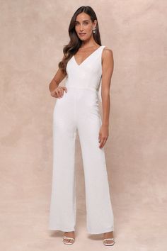 Walking in like you own the place is exactly how the Lulus Feeling Sparkly White Sequin Bow Wide-Leg Jumpsuit is supposed to make you feel! This fabulous jumpsuit is sure to make you the shiniest sight in any room with its dazzling white sequin composition that shapes a princess-seamed bodice with a V-neckline and a flirty open back design, all supported by wide straps. The high fitted waist tops trendy wide pant legs that fall to ankle-grazing hems. The dramatic, oversized bow detail at the back is sure to make heads turn and secures via snap closures for easy on-and-off! Hidden back zipper/clasp. Fit: This garment fits true to size. Length: Floor length. Size medium measures 57" from shoulder to hem. Inseam: 31.25 Front Rise: 13.75 Bust: Great for any cup size. Waist: Fitted - very fitte Glamorous White Sequined Jumpsuits And Rompers, Glamorous Sleeveless Jumpsuits And Rompers For Wedding, Glamorous Sleeveless Jumpsuits For Weddings, Glamorous Sleeveless Wedding Jumpsuits And Rompers, Party Outfit Formal, Bow Jumpsuit, Casual Formal Dresses, Tops Trendy, Wedding Jumpsuit