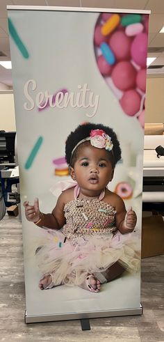 a sign that says serenity with an image of a baby wearing a tutu