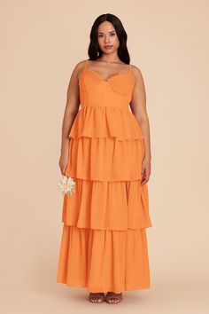 a woman wearing an orange tiered dress