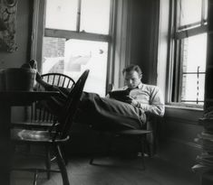 a man sitting in a chair reading a book