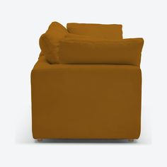 a brown couch with pillows on top of it