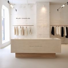 an empty clothing store with clothes on racks