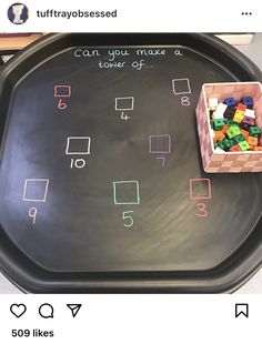 a tray that has some sort of blackboard on it with colored letters and numbers