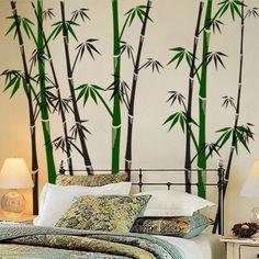 a bed room with a neatly made bed and lots of bamboo trees on the wall