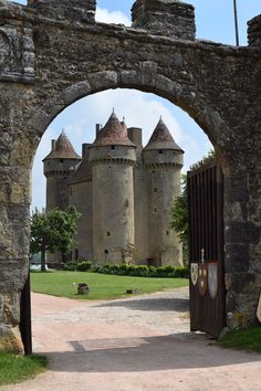 the entrance to an old castle with stone walls and towers on either side is a gate