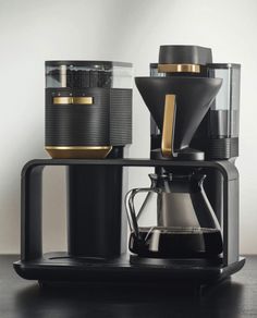 a coffee maker sitting on top of a wooden table