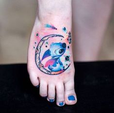 a person with a tattoo on their foot that has an image of stitching in the moon