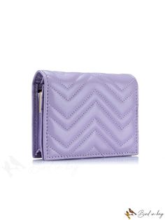 a women's wallet is shown with the zipper open and has a chevron pattern on