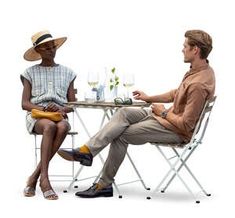 two people sitting at a table with wine glasses