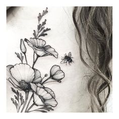 a woman's neck with flowers and a bee on it