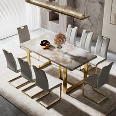 a dining room table with chairs and a vase on the floor in front of it