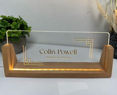 a wooden stand with a glass sign on it