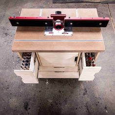 an overhead view of a table sawing machine on top of a piece of wood