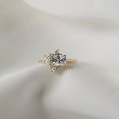 a diamond ring sitting on top of a white cloth