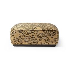 a brown and black ottoman with an intricate pattern on it's back end, in front of a white background