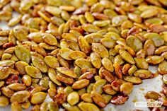 pumpkin seeds on a baking sheet ready to be baked