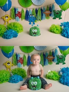 a baby sitting on the ground in front of some green and blue paper fan decorations