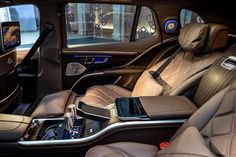 the interior of a luxury car with leather seats and touchscreens, including an ipod