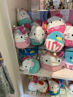 hello kitty stuffed animals are on shelves in a store, one is pink and the other is blue