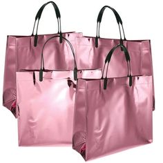 two pink shopping bags with black handles