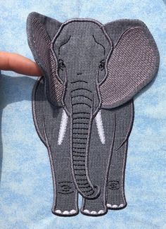 an elephant embroidered onto a blue shirt