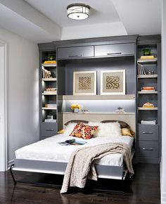 a bed sitting in a bedroom next to a book shelf