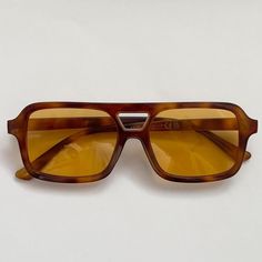 This vintage-inspired aviator is made from brown tort shell acetate and paired with a tan / orange coloured lens. This style is unisex. Dimensions:  Temple length: 14.5cm Lens width: 5.3cm Height: 4.1cm High Quality with UV protection.  Sunglasses are carefully packaged in bubble wrap to ensure they arrive to you in perfect condition 99p UK Shipping We ship using Royal Mail 2nd class and dispatch the same working day if ordered before 2pm. There is also an option at checkout to upgrade your ship Brown Lens Sunglasses, Sunglasses Orange Lens, Brown Square Frame Aviator Sunglasses With Uva Protection, Brown Aviator Sunglasses With Anti-reflective Square Frame, Brown Square Frame Aviator Sunglasses With Anti-reflective Coating, Brown Square Frame Anti-reflective Aviator Sunglasses, Brown Anti-reflective Aviator Sunglasses For Summer, Casual Brown Square Frame Aviator Sunglasses, Retro Yellow Aviator Sunglasses With Tinted Lenses