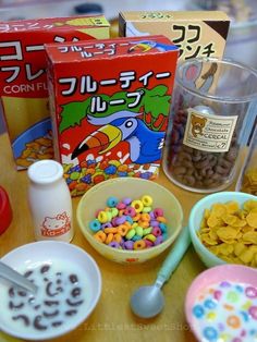 various cereals, milk and other foods are on a table with japanese characters in the background