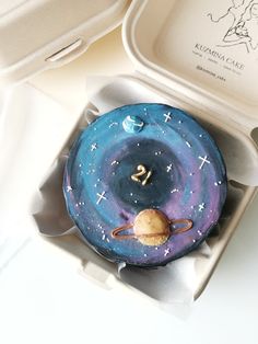 a cake in a box with the number twenty on it and an astro sign painted on top