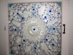 a decorative glass door with blue and white decorations