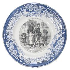 a blue and white plate with an image of people on it