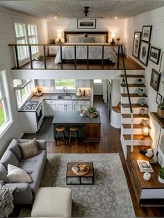 a living room filled with furniture next to a kitchen and dining area in a house