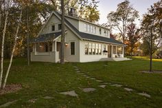 a white house surrounded by trees and grass