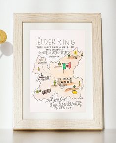 a white frame with a drawing of the state of elderking on it and an orange flower next to it