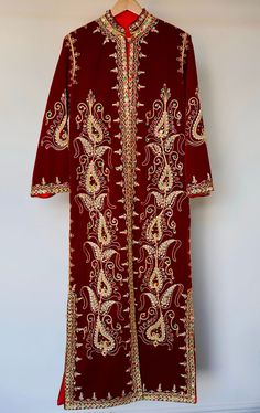 Your 1970s caftan dress represents a timeless piece of elegance, skillfully blending oriental tradition with vintage refinement. Its elaborate manual embroideries, crafted with golden thread, semi-precious pearls, and delicate sequins, showcase the exceptional craftsmanship of its time. Every detail reflects the artisanal mastery of that era, highlighting the passion and devotion of the creators behind this sartorial masterpiece. The dress's pristine condition, preserved like new, serves as evidence of meticulous care throughout the decades. More than just a garment, it becomes a chronicle of timeless elegance and the tradition of beauty. It carries not only the history of fashion but also the imprint of an era where textile art and intricate details reached their zenith. Dimensions: 40 in Traditional Maxi Dress With Traditional Patterns, Traditional Maxi Dress With Zari Work, Traditional Long Sleeve Maxi Dress For Festivals, Traditional Maxi Dress With Intricate Embroidery For Festivals, Traditional Ceremonial Long Sleeve Maxi Dress, Bohemian Kaftan With Zari Work For Transition Season, Festive Floor-length Kaftan For Transitional Season, Festive Elegant Multicolor Embroidered Kaftan, Elegant Festive Multicolor Embroidered Kaftan