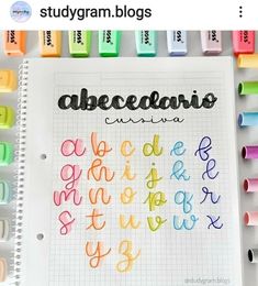 an open notebook with colorful crayons on it and the words abc, c, d