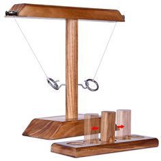 a wooden balance scale with scissors on it