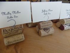 four wine corks with place cards on them