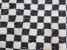 a black and white checkered rug is shown